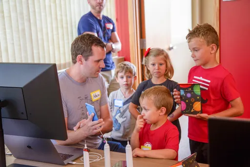 Adam with kids at community event